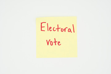 Electoral vote written on a yellow sticky note with copyspace. Presidential election 2020