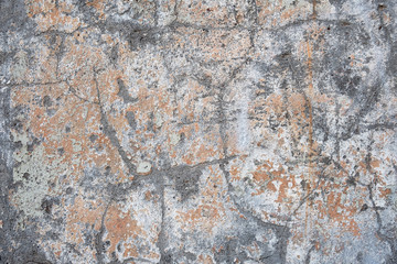 old aged gray concrete wall with white and beige paint stains and scratches. rough surface texture