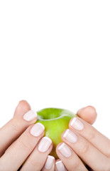 Green apple in hands, closeup. Diet concept