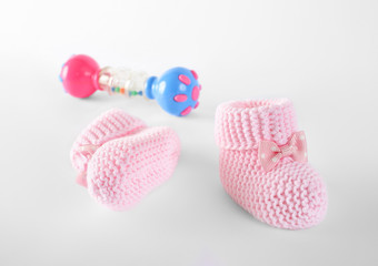 pink baby booties and toy on isolation