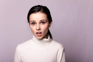 Fototapeta premium girl in a white turtleneck, portrait on a gray background