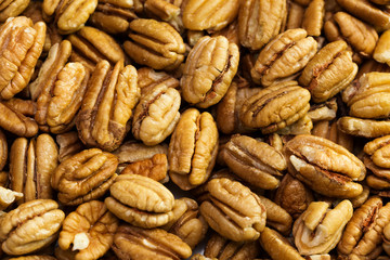 Pecan nuts background. Closeup pekan seeds