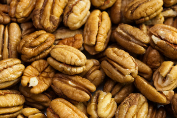 Pecan nuts background. Closeup pekan seeds