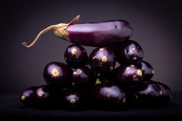 Lot of small colourful vibrant purple baby eggplant aubergine vegetable