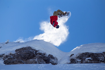 Snowboarder does backflip in backcountry