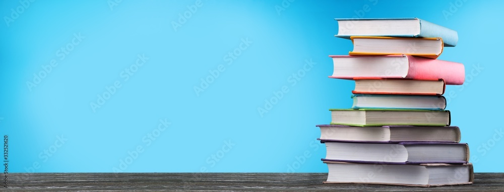 Canvas Prints stack of colorful school books on wooden desk