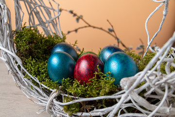 Easter holiday concept. Dyed Easter eggs in a moss. 