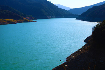 a beautiful summer landscape along the San Gabriel River with majestic mountain ranges, lush green...