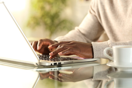 Black Man Hands Typing On A Laptop At Home