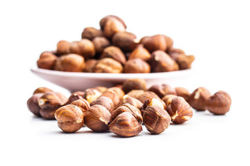 Peeled hazelnuts on white background.