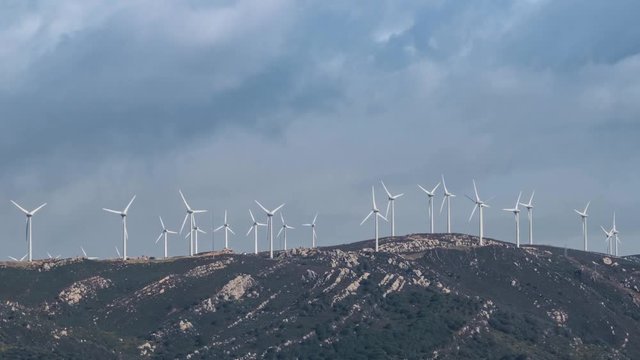 Timelapse of wind turbines producing green electricity on a mountain in Tarifa, Spain