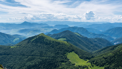 Naklejka premium Panorama of mountains and blue sky, misty horizon