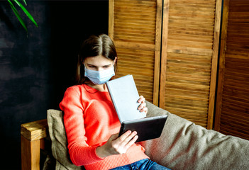 Obraz premium Student on laptop and tablet, online distance education, coronavirus and pandemic. covid-19.Young girl learning foreign languages, digital self education, studying online