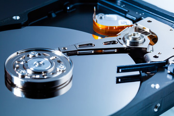 An open computer hard drive for repair. HDD. Components for ps. Storage and restoration of digital...