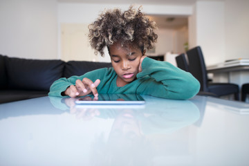 Child surfing internet on tablet computer.