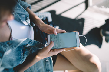 Woman using smartphone while resting in city park