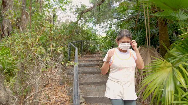 411 Woman walking into nature with face mask and then breathing