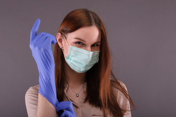 Woman in protective mask teaching How to wearing gloves for protect Covid-19 (coronavirus)