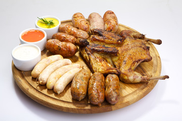 Easter sausage isolated on white background. Grilled dish with sauce on a wooden background
