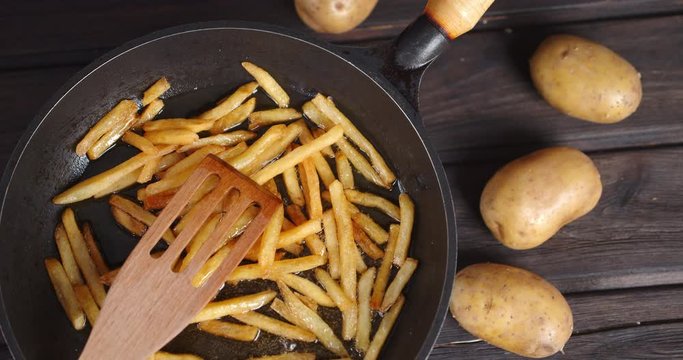 French fries fried in the pan. Rotates slowly.