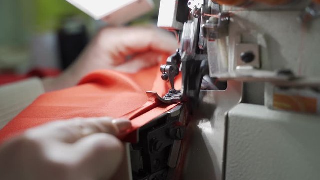 Female master tailor in making preparations for the red dress