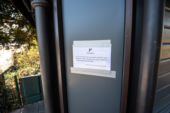 Inscription in French language translated as During Coronavirus Covid 19 we remain closed - ice-cream store in French park in Strasbourg during national French outbreak