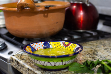 Delicious mexican dish called pozole in a colorful plate on a table
