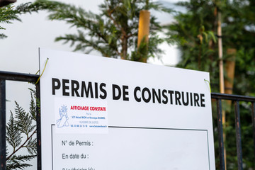 Paris, France - Mar 18, 2020: Permis de construire translated as Construction permit on the facade of a hotel house in France