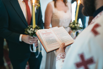  The bride and groom stand at their church wedding