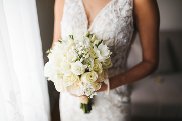 A beautiful bride in a wedding dress with a bouquet in her hand