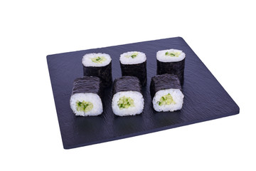 Traditional fresh japanese sushi maki on black stone Maki Capa on a white background. Roll ingredients: Cucumber, Nori, Rice.
