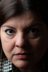 Obraz premium Lady head shot studio extreme closeup portrait. She is seriousious and looking to the camera.
