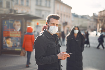 People in the city. Persons in a masks. Coronavirus theme. Couple walks during quarantine.