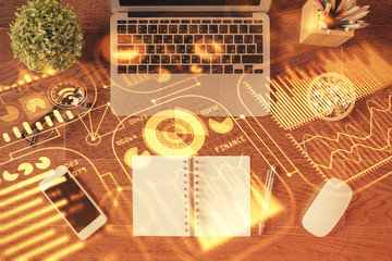 Technology hologram drawing over computer on the desktop background. Top view. Double exposure. Tech concept.