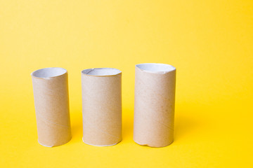 three toilet paper bushes on a yellow background copy space, toilet paper has ended, crisis 2020, a joke about the hype