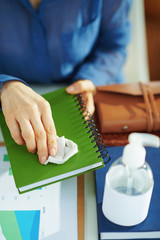 woman sanitising stuff with disinfectant