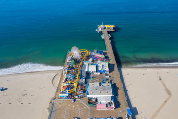 Aerial view of empty Santa Monica pier with no people in Los Angeles California as result of  coronavirus pandemic or COVID-19 virus outbreak and lockdown