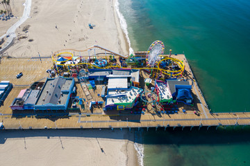 Aerial view of empty Santa Monica pier with no people in Los Angeles California as result of  coronavirus pandemic or COVID-19 virus outbreak, lockdown and quarantine