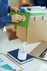 modern woman sanitising stuff with disinfectant