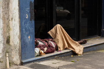 homeless man sleeps on the streets succesptible to covid-19 in SP