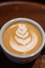 A bird's eye view of white coffee with cocoa , white coffee with black background, coffee served in cafe, morning cappuccino, macchiato in a professional way