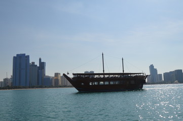 Abu Dhabi city skyline along Corniche beach taken from a boat