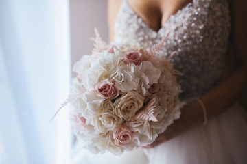 A beautiful bride in a wedding dress with a bouquet in her hand