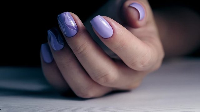 Beautiful female hands with violet manicure. Fingers with fresh e look manicure at short  nails. Trend of natural beauty concept.