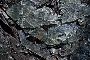 Broken glass on floor background, top view, abstract