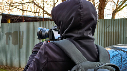 Street photographer shoots from monopod