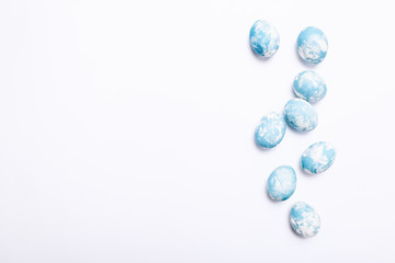 Stylish eggs with ombre blue marble stone effect on white background