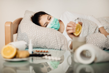 Sick woman in bed.Pneumonia disease.Flu infected patient with protective mask suffering from...