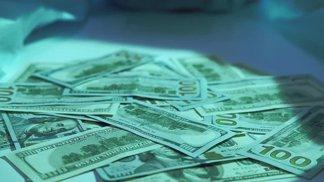 Fee-for-service medicine. Health insurance. Surgeon hands in protective gloves grabbing money pile.