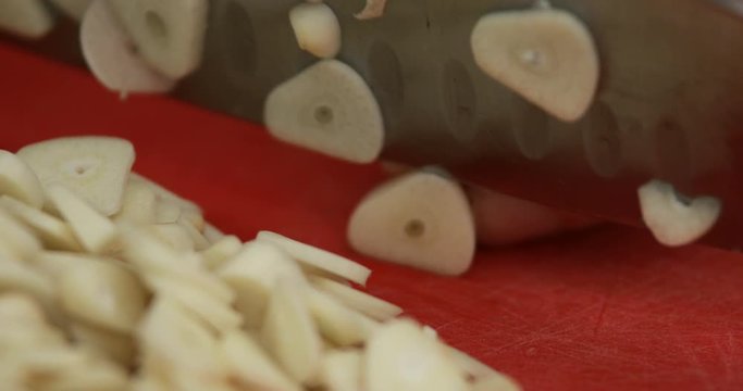 Home made dried garlic powder, raw garlic chopped using sharp kitchen knife, close-up